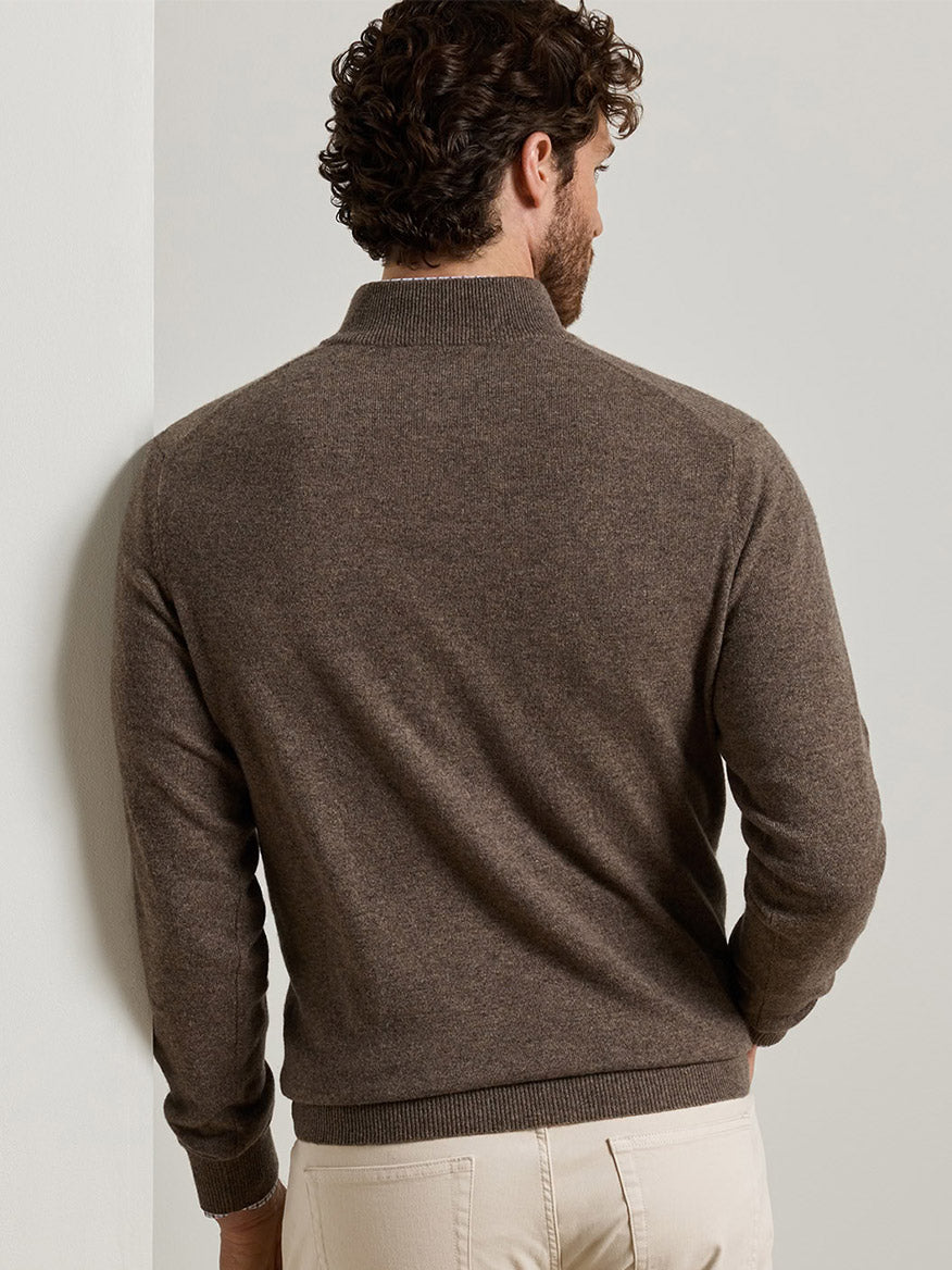 Back view of a man wearing a Peter Millar 25th Anniversary Cashmere Quarter-Zip Sweater in Sawgrass, a classic fit, brown quarter-zip sweater with ribbed cuffs and hem.