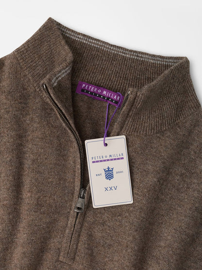 Peter Millar 25th Anniversary Cashmere Quarter-Zip Sweater in Sawgrass, a brown cashmere sweater in a classic fit with a zippered collar and a 25th anniversary hang tag at the neckline.