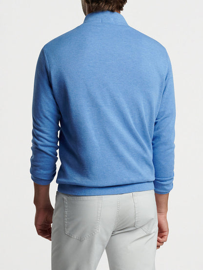 A man seen from the back wearing a Peter Millar Crown Comfort Pullover in Maritime and light grey pants.