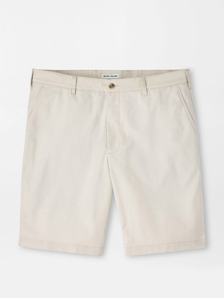 Peter Millar Crown Comfort Short in Stone: Beige knee-length chino shorts with four-way stretch, belt loops, front button and zip closure, and side pockets, shown flat on a white background.