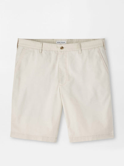Peter Millar Crown Comfort Short in Stone: Beige knee-length chino shorts with four-way stretch, belt loops, front button and zip closure, and side pockets, shown flat on a white background.