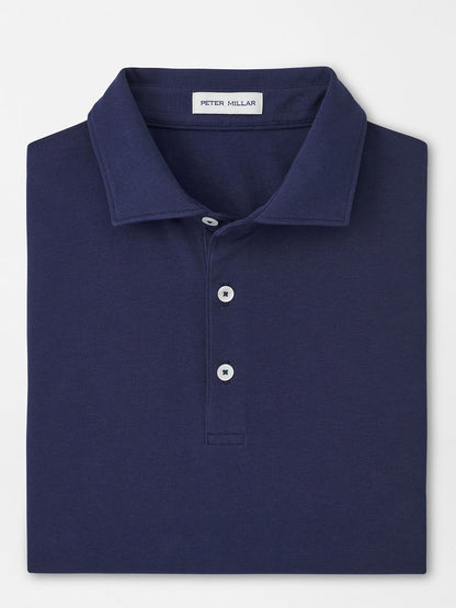 A folded navy Peter Millar Crown Flex Cotton Polo, classic fit with a collar and three buttons, featuring the brand’s label inside the neckline.