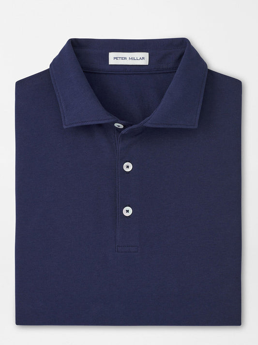 A folded navy Peter Millar Crown Flex Cotton Polo, classic fit with a collar and three buttons, featuring the brand’s label inside the neckline.