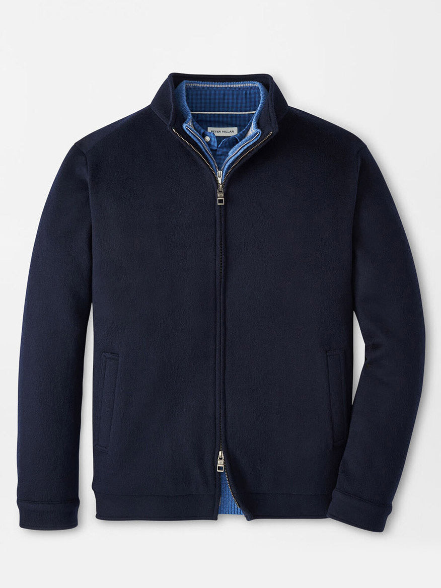The Peter Millar Crown Flex Merino Bomber in Navy features a stand collar, two side pockets, and a blue inner lining. Crafted from merino wool, this jacket is displayed flat.