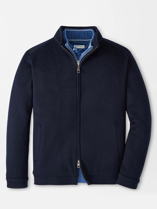 The Peter Millar Crown Flex Merino Bomber in Navy features a stand collar, two side pockets, and a blue inner lining. Crafted from merino wool, this jacket is displayed flat.
