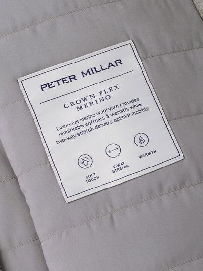 A grey Peter Millar Crown Flex Merino Vest in a classic quilted fit, featuring a label detailing the stretch-knit construction for softness, warmth, and mobility.
