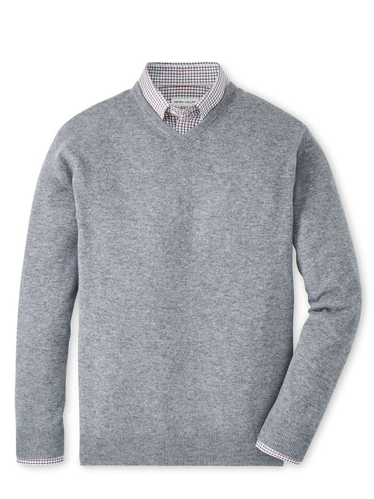 The Peter Millar Crown Heritage Cashmere V-Neck Sweater in Oslo Grey is layered over a collared, checkered shirt and displayed flat against a white background.