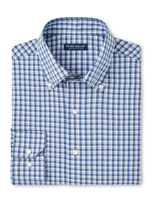 Folded Peter Millar Davis Performance Poplin Sport Shirt in Ocean Blue, featuring a blue and white checkered pattern, button-up style with collar, and made from easy-care performance fabric.