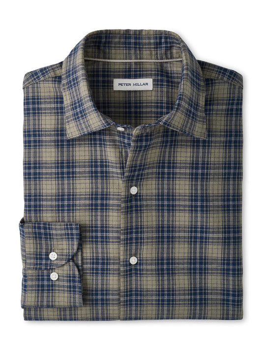 A folded, long-sleeve button-up shirt showcasing a blue and tan plaid pattern, with the “Peter Millar” label visible inside the collar. The Peter Millar Dean Performance Flannel Sport Shirt in Fatigue is crafted from soft performance fibers, blending timeless style with modern comfort—ideal for fans of Peter Millar flannels.