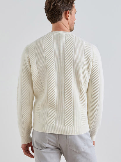 Back view of a man wearing a Peter Millar Dolomite Crewneck Sweater in Almond, a tailored-fit, off-white crewneck featuring a diagonal ribbed pattern.
