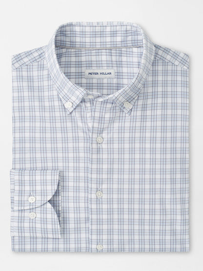 The Peter Millar Douglas Crown Lite Cotton-Stretch Sport Shirt in Gale Grey features a blue and light gray plaid pattern, classic fit, moisture-wicking stretch cotton, and a signature label on the inside collar.