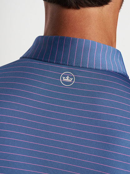 Close-up of the back collar of a striped Peter Millar Duet Performance Jersey Polo in Blue Pearl with a logo.