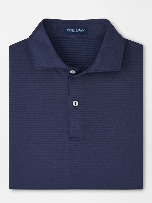 The Peter Millar Empire Performance Jersey Polo in Navy features a subtle stripe pattern, two white buttons, and a four-way stretch fabric with UPF 50+ sun protection.