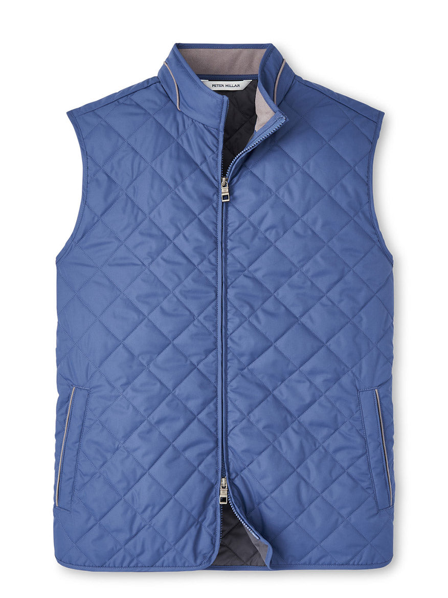 The Peter Millar Essex Vest in Galaxy is a blue, sleeveless, water-resistant quilted vest with a zip-up front and two pockets.