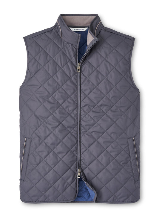 The Peter Millar Essex Vest in Iron showcases a gray, quilted zip-up design with side pockets and a high neck collar, crafted from windproof quilted fabric for enhanced durability.