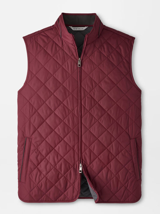 The Peter Millar Essex Vest in Bordeaux is a maroon quilted vest featuring a front zipper, two zippered side pockets, and a stand collar, designed as a stylish windproof layer and shown on a plain white background.