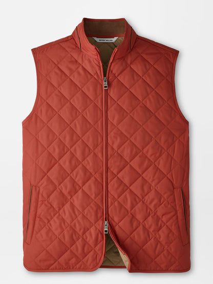 The Peter Millar Essex Vest in Burnt Orange, a sleeveless quilted vest featuring water-resistant fabric, a front zipper closure, and two side pockets, is laid flat on a white background.