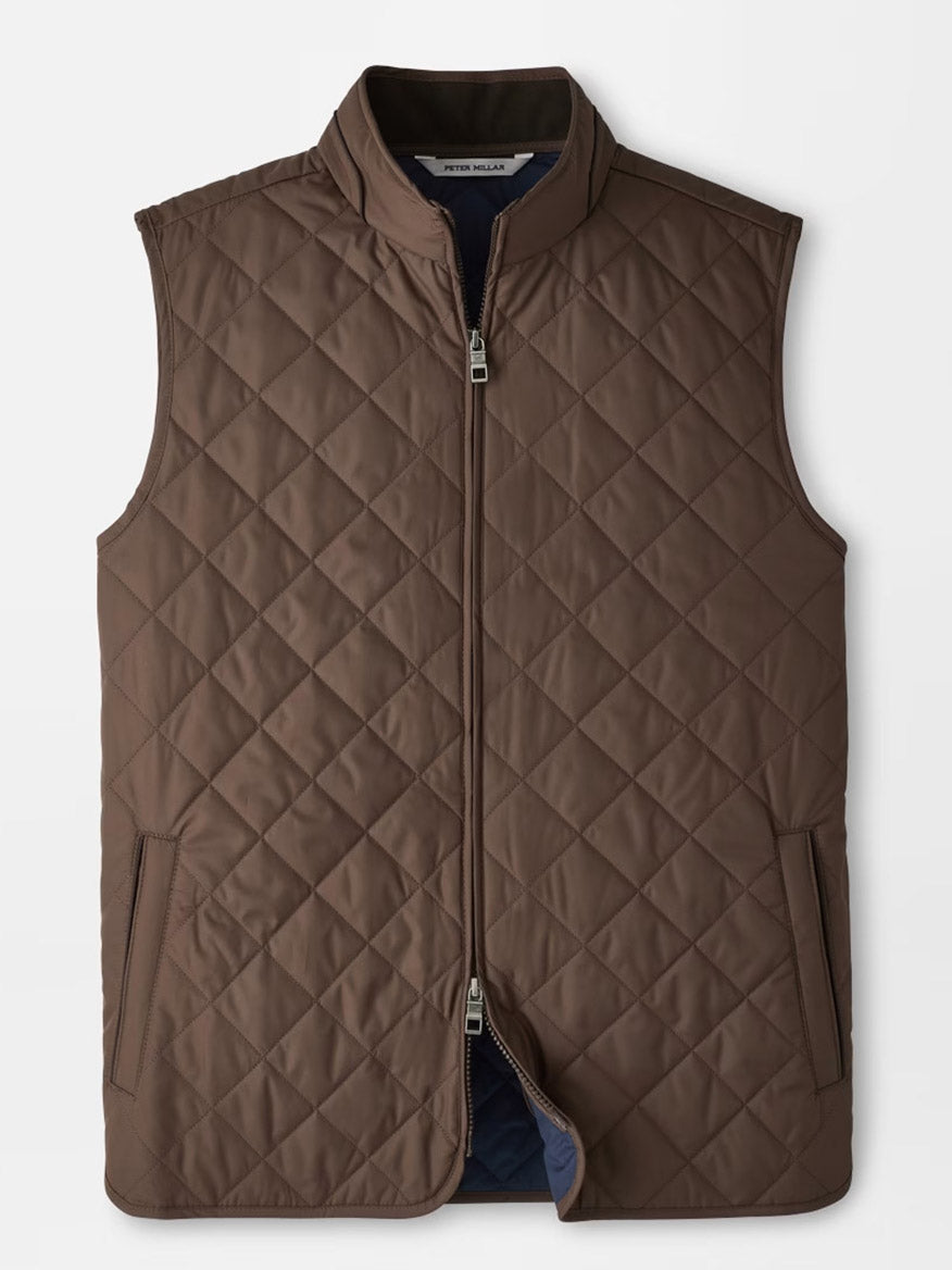 Peter Millar Essex Vest in French Press, featuring a quilted design with a front zipper, two side pockets, and a stand collar, is laid flat on a white background. This windproof vest combines style and warmth—ideal for cooler days.