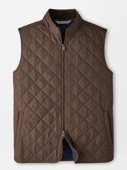 Peter Millar Essex Vest in French Press, featuring a quilted design with a front zipper, two side pockets, and a stand collar, is laid flat on a white background. This windproof vest combines style and warmth—ideal for cooler days.