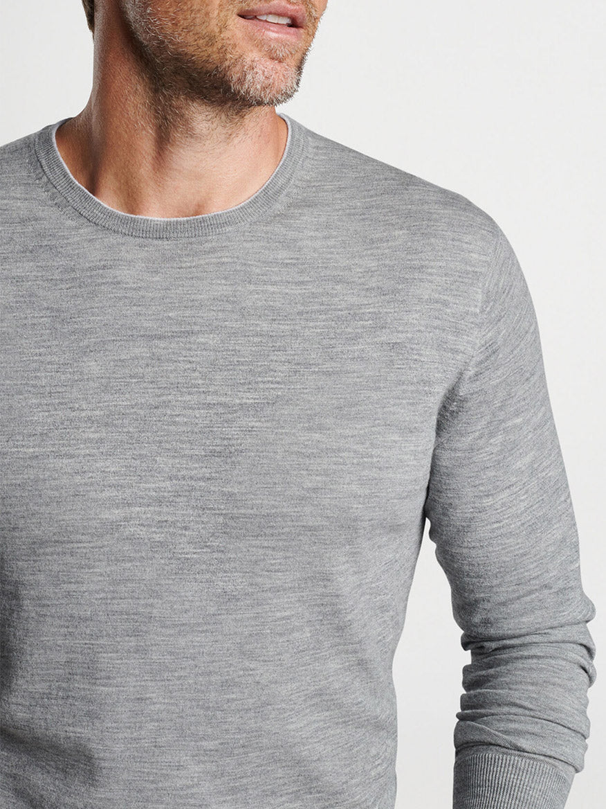 Man wearing a Peter Millar Excursionist Flex Crew in Gale Grey sweater, cropped image showing from the chest up.