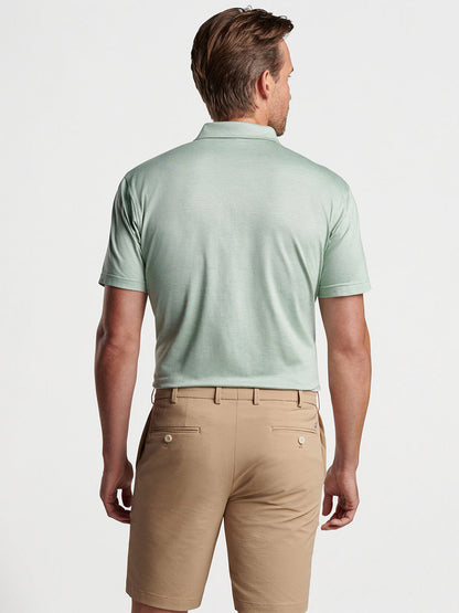 Peter Millar, a man in an Peter Millar Excursionist Flex Short-Sleeve Polo in Sage Fog, showcasing refined casual style.