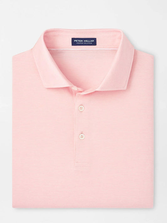 The Peter Millar Excursionist Flex Polo in Pink Crepe is a light pink, collared shirt with two buttons, featuring a brand label inside the neckline and crafted from comfortable four-way stretch fabric.