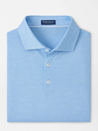 A neatly folded Peter Millar Excursionist Flex Polo in Blue Topaz with a collar, three buttons, and "Peter Millar" label inside the neckline, crafted from soft cotton jersey knit.