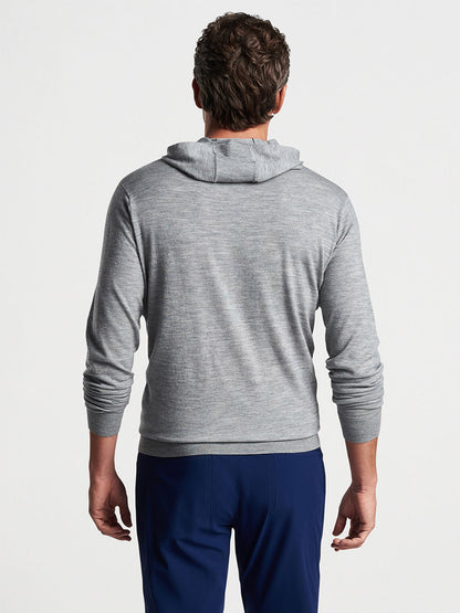 Man from behind wearing a Peter Millar Excursionist Flex Popover Hoodie in Gale Grey and navy blue pants.
