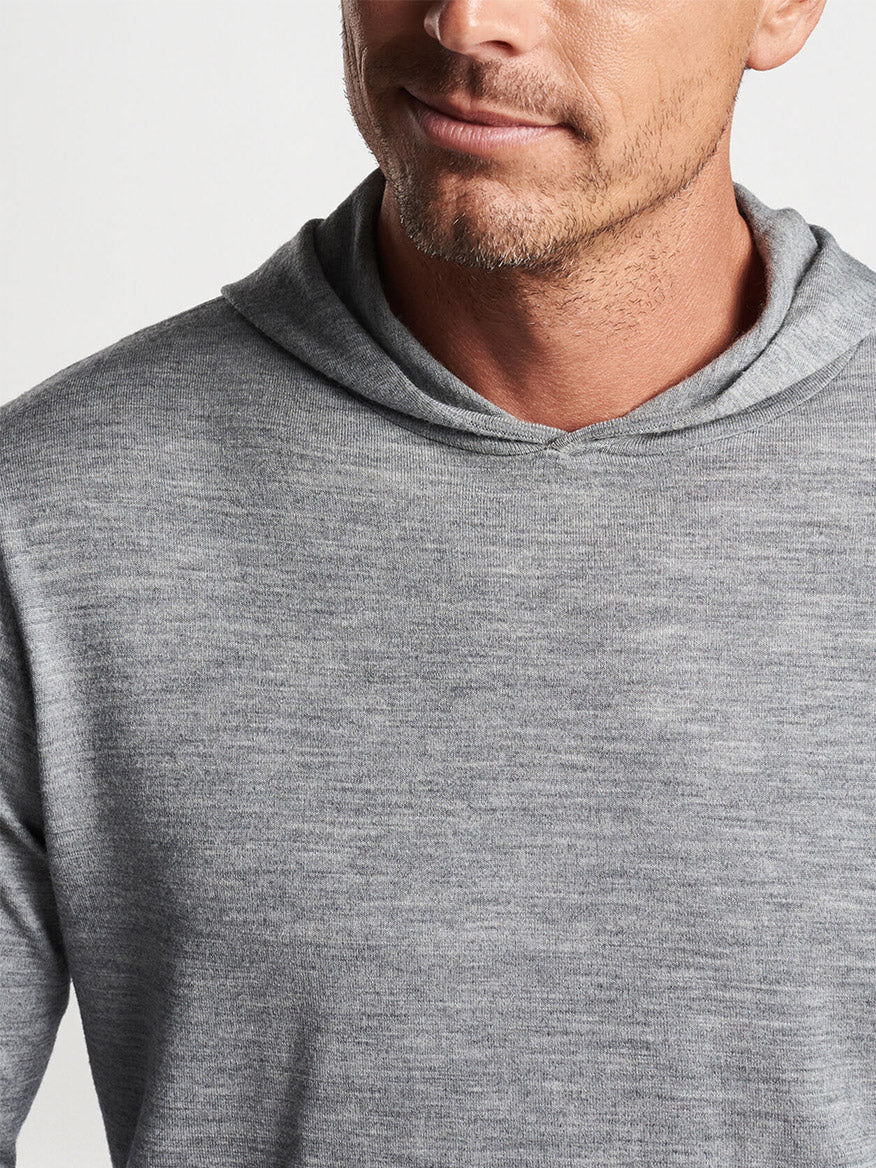 A man wearing a Peter Millar Excursionist Flex Popover Hoodie in Gale Grey, cropped to show from the nose down.