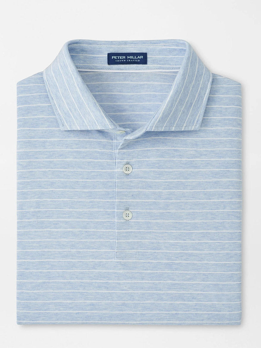 A neatly folded Peter Millar Excursionist Flex Striped Polo in Blue Frost, featuring white horizontal stripes, a collar, and a two-button placket in soft cotton jersey knit.