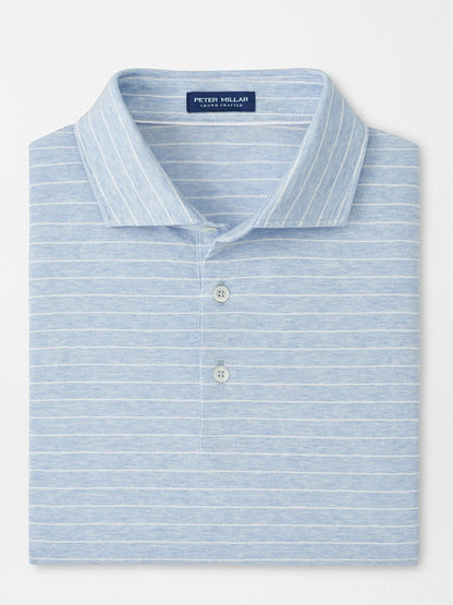 A neatly folded Peter Millar Excursionist Flex Striped Polo in Blue Frost, featuring white horizontal stripes, a collar, and a two-button placket in soft cotton jersey knit.