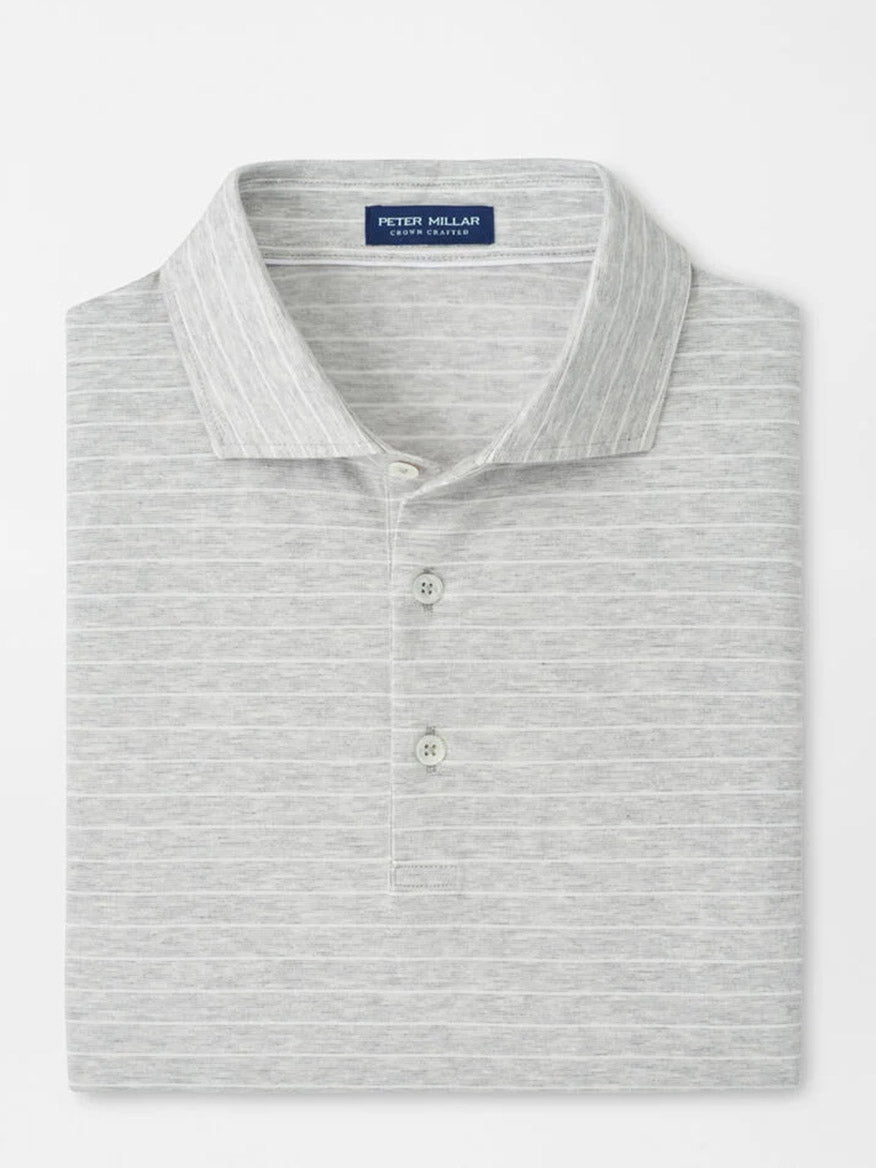 The Peter Millar Excursionist Flex Striped Polo in British Grey is a short-sleeve light grey polo with subtle stripes, crafted from soft cotton jersey, featuring a two-button placket and "Peter Millar" label inside the collar.