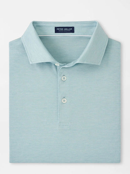 The Peter Millar Excursionist Flex Polo in Blue Spruce is crafted from a cotton-based jersey knit and features a collar with three buttons. Neatly folded, it offers four-way stretch for ultimate comfort.