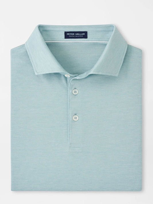 The Peter Millar Excursionist Flex Polo in Blue Spruce is crafted from a cotton-based jersey knit and features a collar with three buttons. Neatly folded, it offers four-way stretch for ultimate comfort.