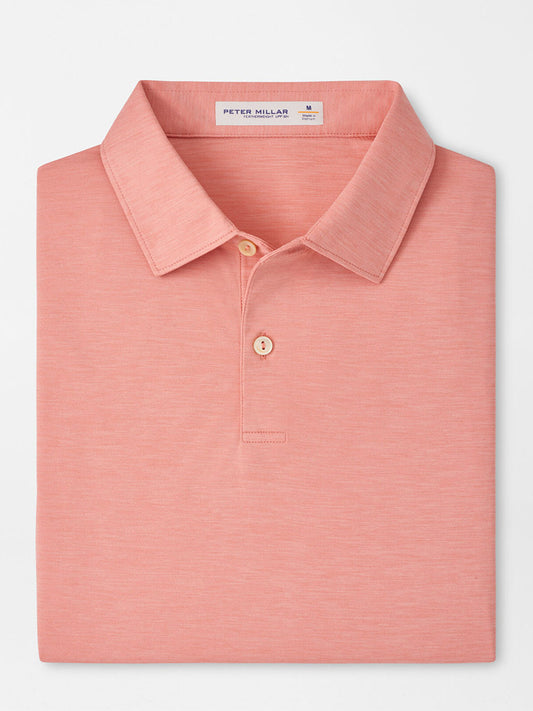 A neatly folded Peter Millar Featherweight Mélange Performance Polo in Venetian Pink, featuring a collar, two buttons, and UPF 50+ sun protection, displayed against a plain white background.