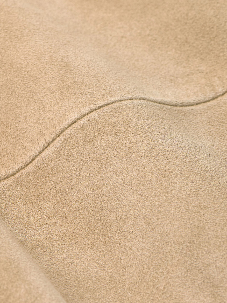 Close-up of the Peter Millar Featherweight Suede Shirt Jacket in Sand, featuring visible stitching and a soft texture.