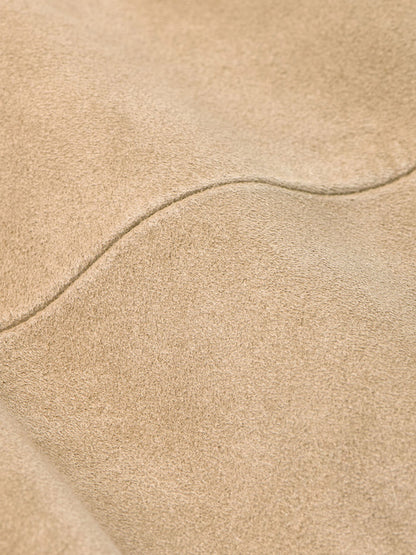 Close-up of the Peter Millar Featherweight Suede Shirt Jacket in Sand, featuring visible stitching and a soft texture.