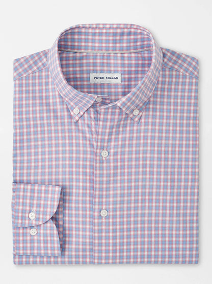 A neatly folded, long-sleeve button-down shirt with a blue, pink, and white checkered pattern. The label inside the collar reads "Peter Millar Felix Crown Lite Cotton-Stretch Sport Shirt in Chili Red.