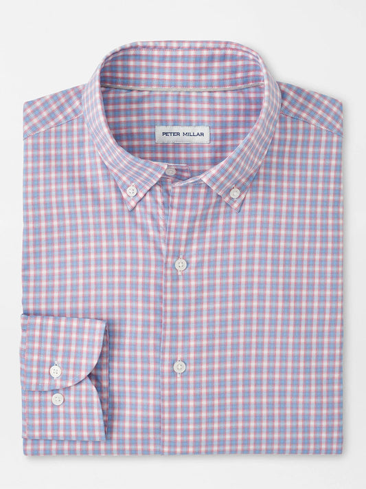 A neatly folded, long-sleeve button-down shirt with a blue, pink, and white checkered pattern. The label inside the collar reads "Peter Millar Felix Crown Lite Cotton-Stretch Sport Shirt in Chili Red.