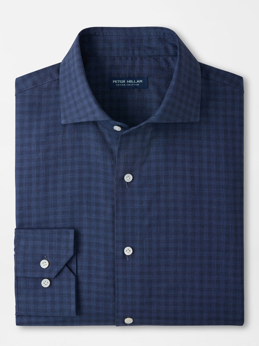The Peter Millar Felix Cotton Sport Shirt in Navy is a folded long-sleeve sport shirt made from dark blue checked cotton poplin, complete with white buttons and enhanced with a Flex Finish for added comfort, displayed on a plain white background.
