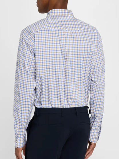 A person is seen from the back wearing a blue and yellow checkered Peter Millar Gardner Crown Lite Cotton-Stretch Sport Shirt in Blue Freesia and dark pants.