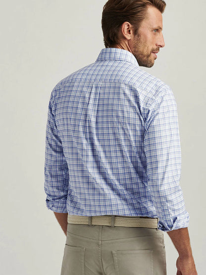 A man in a Peter Millar Garrow Crown Lite Cotton-Stretch Sport Shirt, Blue Freesia, with beige pants, facing away.