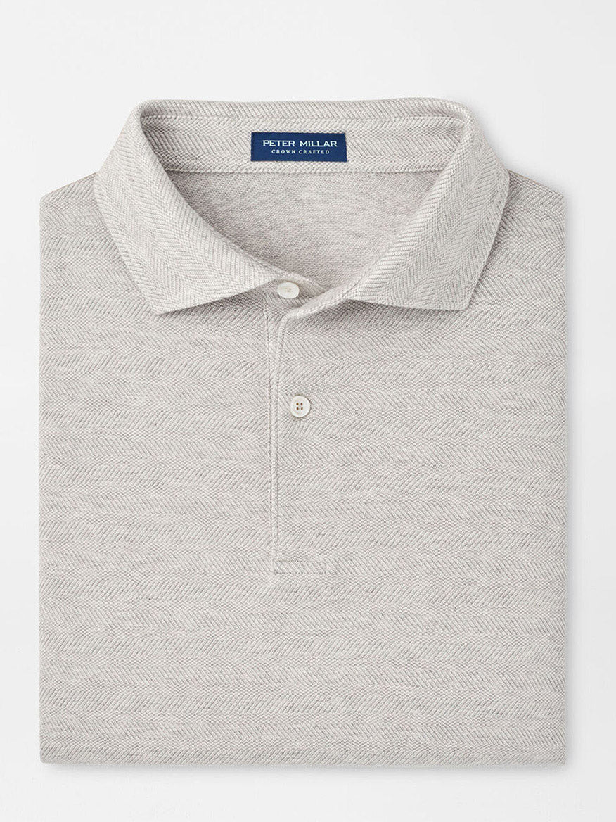 A Peter Millar Harris Herringbone Knit Polo in British Grey, tailored for a perfect fit, with a cotton-blend and subtle herringbone pattern, features the "Peter Millar" label on the collar.