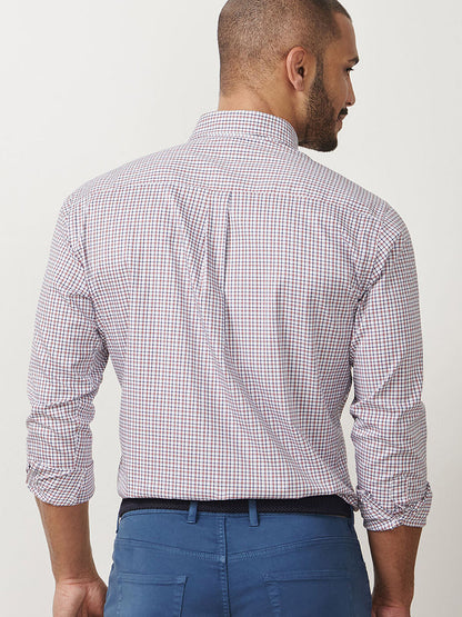A man with short hair stands facing away, wearing the Peter Millar Julian Crown Lite Cotton-Stretch Shirt in Navy and blue pants.