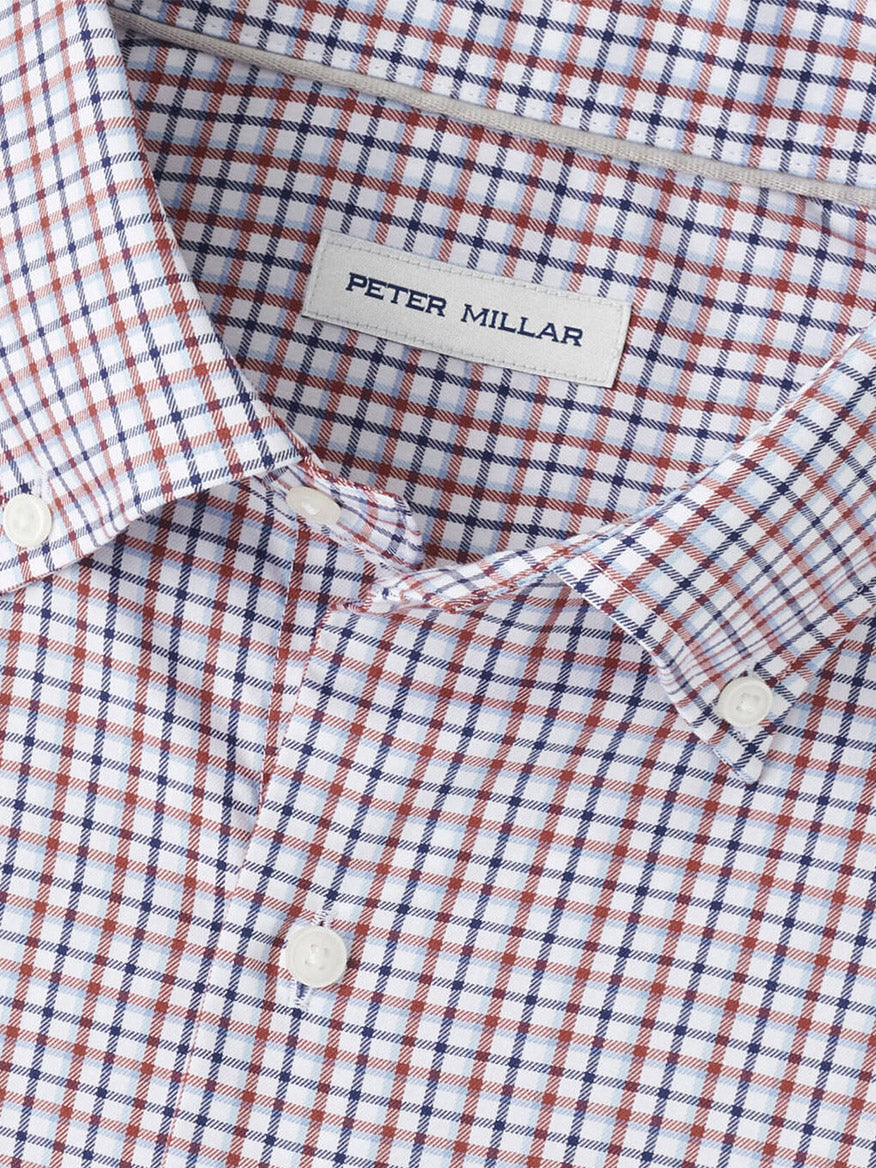 Close-up of the Peter Millar Julian Crown Lite Cotton-Stretch Shirt in Navy, showcasing a red, blue, and white checkered pattern, made from easy-care cotton-stretch fabric for effortless style.