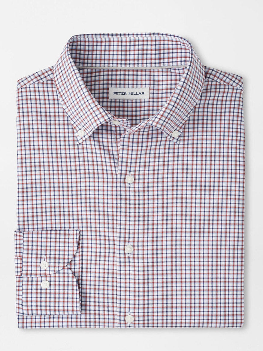 A folded long-sleeve button-up shirt with a navy checkered pattern, crafted from easy-care fabric, features a "Peter Millar" label and is named the Peter Millar Julian Crown Lite Cotton-Stretch Shirt in Navy.