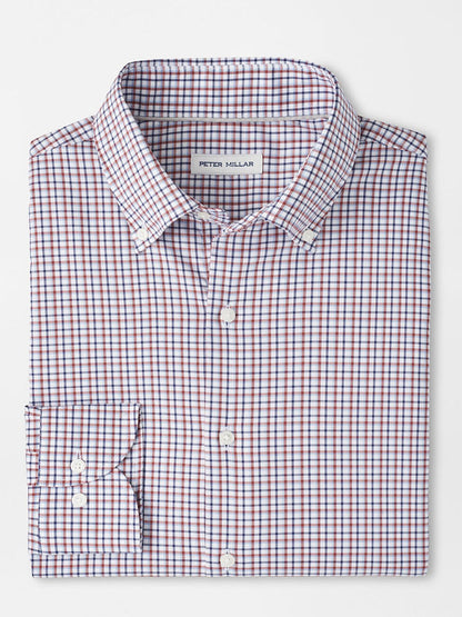 A folded long-sleeve button-up shirt with a navy checkered pattern, crafted from easy-care fabric, features a "Peter Millar" label and is named the Peter Millar Julian Crown Lite Cotton-Stretch Shirt in Navy.