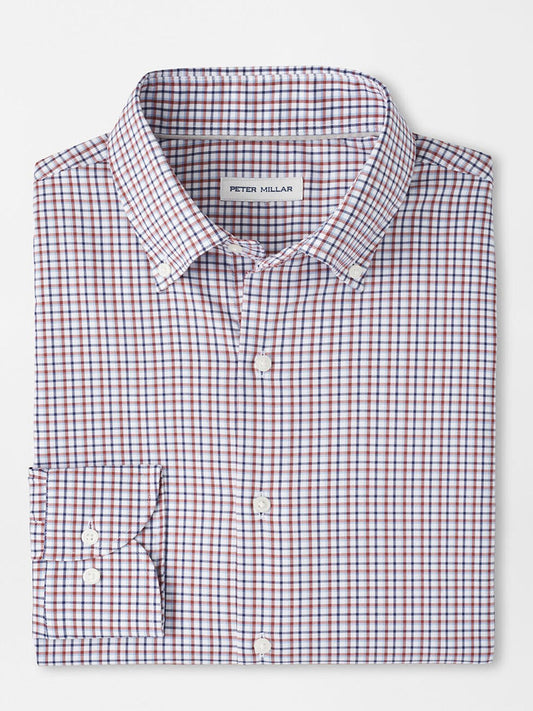 A folded long-sleeve button-up shirt with a navy checkered pattern, crafted from easy-care fabric, features a "Peter Millar" label and is named the Peter Millar Julian Crown Lite Cotton-Stretch Shirt in Navy.
