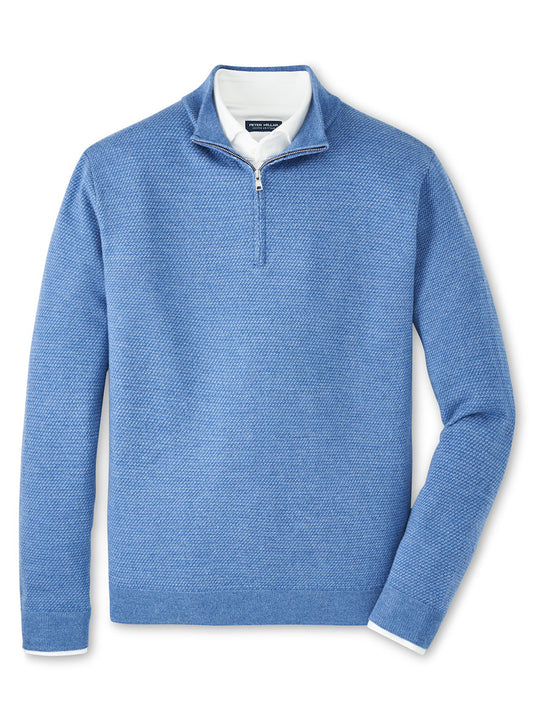 The Peter Millar Keene Quarter-Zip Sweater in Lunar Blue, a tailored midweight pullover, is displayed layered over a white collared shirt on a flat, white background.