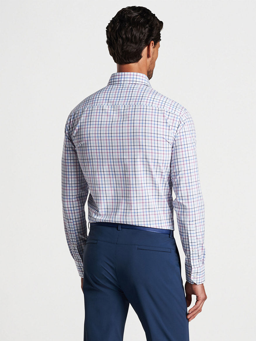 Man wearing a Peter Millar Kimball Performance Poplin Sport Shirt in Valencia and blue trousers viewed from the back with UPF 50+ protection.